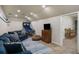 Finished basement with a TV and a blue sectional sofa at 4415 Saint Andrews Crest Dr, Cumming, GA 30040