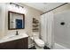 Bathroom features a vanity with a dark wood cabinet and a shower and tub combo at 4415 Saint Andrews Crest Dr, Cumming, GA 30040