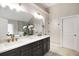 Bathroom featuring a double sink vanity with modern fixtures and a glass-enclosed shower at 4415 Saint Andrews Crest Dr, Cumming, GA 30040