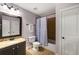 Bathroom featuring a vanity with a marble countertop and a shower with a curtain at 4415 Saint Andrews Crest Dr, Cumming, GA 30040