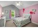 Charming bedroom with pink accent wall and a vanity at 4415 Saint Andrews Crest Dr, Cumming, GA 30040