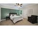 Comfortable bedroom features paneled accent wall, ceiling fan, neutral decor and carpet at 4415 Saint Andrews Crest Dr, Cumming, GA 30040