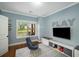 Playful bonus room with blue walls, a gray rug, and a window view at 4415 Saint Andrews Crest Dr, Cumming, GA 30040