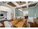 Elegant dining room with coffered ceiling, wainscoting, and a large wooden table at 4415 Saint Andrews Crest Dr, Cumming, GA 30040