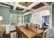 Well-lit dining room with a large window, coffered ceilings, and stylish light fixture at 4415 Saint Andrews Crest Dr, Cumming, GA 30040