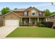 Charming two-story home with brick and stone accents, manicured lawn, and a welcoming front porch at 4415 Saint Andrews Crest Dr, Cumming, GA 30040