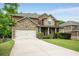 Beautiful two-story brick home with stone accents, manicured lawn, and a spacious driveway at 4415 Saint Andrews Crest Dr, Cumming, GA 30040