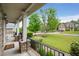Inviting front porch with stone pillars, black railings, and green landscaping at 4415 Saint Andrews Crest Dr, Cumming, GA 30040
