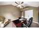 Home office with a large desk, leather chair, ceiling fan and window at 4415 Saint Andrews Crest Dr, Cumming, GA 30040