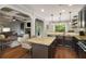 Spacious kitchen with island seating, granite countertops, and views to the living room at 4415 Saint Andrews Crest Dr, Cumming, GA 30040