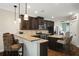 Modern kitchen with granite countertops, dark cabinets, and stainless steel appliances at 4415 Saint Andrews Crest Dr, Cumming, GA 30040