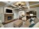 Cozy living room showcasing the fireplace, kitchen access, and neutral decor at 4415 Saint Andrews Crest Dr, Cumming, GA 30040