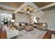 Spacious living area with hardwood floors, stylish furniture, and staircase view at 4415 Saint Andrews Crest Dr, Cumming, GA 30040
