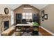 Dedicated home office with stone fireplace, built-in cabinets, and ample workspace at 4415 Saint Andrews Crest Dr, Cumming, GA 30040