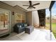 Covered patio with cozy seating, ceiling fan, and access to the backyard at 4415 Saint Andrews Crest Dr, Cumming, GA 30040