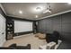 Home theater room with a projector, screen, plush seating, and elegant molding at 4415 Saint Andrews Crest Dr, Cumming, GA 30040