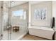 Luxurious bathroom featuring a standalone tub, glass-enclosed shower, and modern fixtures at 522 Boulevard Ne Pl, Atlanta, GA 30308