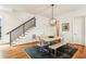 Elegant dining room with hardwood floors, stylish lighting, and staircase to the upper level, creating a warm ambiance at 522 Boulevard Ne Pl, Atlanta, GA 30308