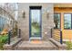 Charming front door framed by brick, modern sconces and a small porch enhancing curb appeal at 522 Boulevard Ne Pl, Atlanta, GA 30308