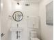 This modern powder room features a wall-mounted sink and round mirror at 522 Boulevard Ne Pl, Atlanta, GA 30308