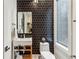 Chic powder room with dark tiled accent wall, vessel sink, and modern fixtures at 522 Boulevard Ne Pl, Atlanta, GA 30308