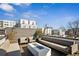 Rooftop deck features comfortable seating and modern fire pit with neighborhood views at 522 Boulevard Ne Pl, Atlanta, GA 30308