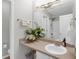 A neutral bathroom featuring a sink, countertop, mirror, towel rack, and a doorway to the shower at 6820 Gallant Se Cir # 2, Mableton, GA 30126