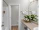 A neutral bathroom featuring a sink, countertop, mirror, towel rack, and a doorway to the shower at 6820 Gallant Se Cir # 2, Mableton, GA 30126