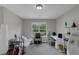 This carpeted bedroom includes a futon sofa, a desk and chair set, and a window allowing natural light at 6820 Gallant Se Cir # 2, Mableton, GA 30126