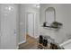 Bright foyer with a mirror, modern light fixture, shoe rack, and wood-look flooring at 6820 Gallant Se Cir # 2, Mableton, GA 30126