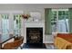 A living room featuring a fireplace, windows, a sofa and a glass door to the patio at 6820 Gallant Se Cir # 2, Mableton, GA 30126