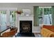 Living room with fireplace, offering a cozy ambiance, complemented by the bright light from the windows at 6820 Gallant Se Cir # 2, Mableton, GA 30126