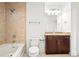 This bathroom features a shower-over-tub, vanity with granite counters and modern fixtures, and tile flooring at 855 Peachtree Ne St # 2001, Atlanta, GA 30308