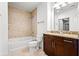 This bathroom features a shower-over-tub, vanity with granite counters and modern fixtures, and tile flooring at 855 Peachtree Ne St # 2001, Atlanta, GA 30308