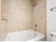 This bathroom features a shower-over-tub with tan tile surround, and a stylish shower head and faucets at 855 Peachtree Ne St # 2001, Atlanta, GA 30308