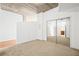 This bedroom includes carpet, an exposed ceiling, and a closet with mirrored sliding doors at 855 Peachtree Ne St # 2001, Atlanta, GA 30308