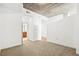 This bedroom has carpet and an exposed ceiling. There is a view into an adjacent bathroom at 855 Peachtree Ne St # 2001, Atlanta, GA 30308