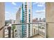 Enjoy a stunning city view from the balcony, overlooking skyscrapers and blue skies with fluffy clouds at 855 Peachtree Ne St # 2001, Atlanta, GA 30308