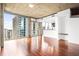 Bright living room with hardwood floors, city views from floor-to-ceiling windows, and an open layout at 855 Peachtree Ne St # 2001, Atlanta, GA 30308