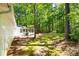 Well maintained backyard with mature trees, a screened porch, and a deck at 121 Danielle Ct, Villa Rica, GA 30180