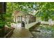 Home exterior showcasing a deck, screened in porch, and tree lined backyard at 121 Danielle Ct, Villa Rica, GA 30180