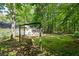 Home exterior showcasing a backyard swing, mature trees, and a screened porch at 121 Danielle Ct, Villa Rica, GA 30180