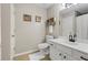 Cozy bathroom features a white vanity, tile floors, and framed artwork at 121 Danielle Ct, Villa Rica, GA 30180
