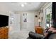 View of the bedroom, the doors to the closet and adjoining room, and a cushioned chair at 121 Danielle Ct, Villa Rica, GA 30180