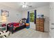 Comfortable bedroom with a window view, ceiling fan, and neutral-colored walls at 121 Danielle Ct, Villa Rica, GA 30180