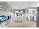 Bright dining area features tile floors, a modern chandelier, and views to the backyard at 121 Danielle Ct, Villa Rica, GA 30180