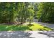 Front exterior of a well-maintained home with lush greenery and a long driveway at 121 Danielle Ct, Villa Rica, GA 30180