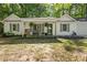 Charming single-story home featuring a cozy front porch and lush landscaping at 121 Danielle Ct, Villa Rica, GA 30180
