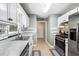 This kitchen is designed with white cabinets, stainless steel appliances, and tiled backsplash at 121 Danielle Ct, Villa Rica, GA 30180