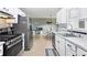 Well-lit kitchen has stainless steel appliances, white cabinets, and a tiled backsplash at 121 Danielle Ct, Villa Rica, GA 30180